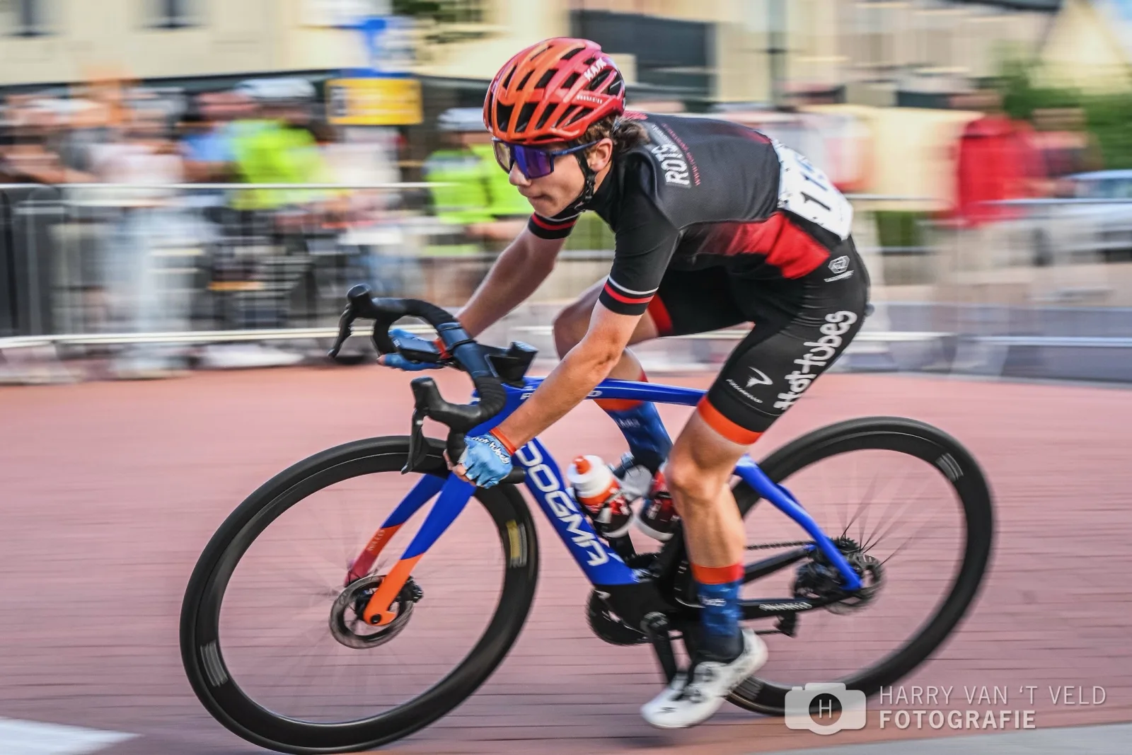 Devin racing past spectators in black kit